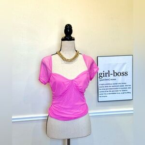 Short-sleeved pink mesh top with a square neckline.